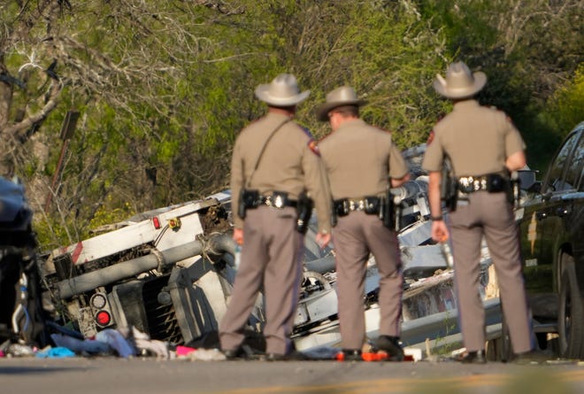 State troopers look at a vehicle that was involved in a fatal school bus crash on SH 21 near Caldwell Road Friday March 22, 2024.